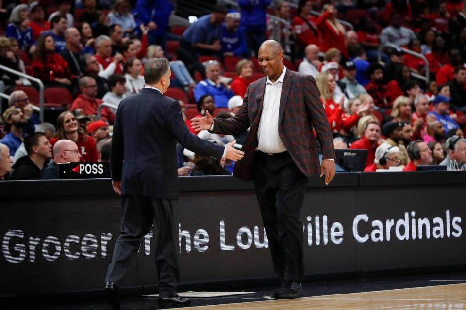 Kentucky head coach John Calipari shakes hands with Louisville counterpart Kenny Payne after Thursday’s game at the KFC Yum Center.