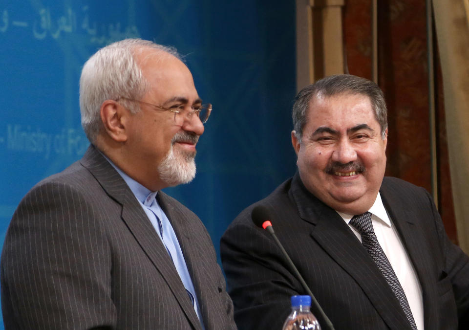 Iraqi Foreign Minister Hoshyar Zebari, right, laughs during a joint press conference with his Iranian counterpart Mohammad Javed Zarif in Baghdad, Iraq, Tuesday, Jan. 14, 2014. (AP Photo/Khalid Mohammed)
