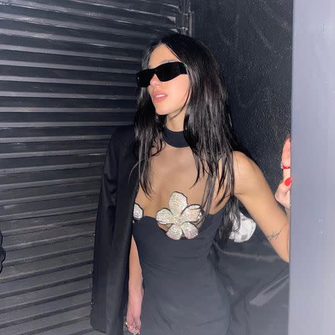 <p>Dua Lipa stepped into celebrity-favourite designer, David Koma, while on a night out in London. The 26-year-old wore an LBD featuring a sheer chest, with two bedazzled flowers acting as bra cups. Lipa paired the turtleneck neckline mini with knee-high boots, an oversized blazer and sunglasses. </p><p><a class="link " href="https://www.matchesfashion.com/womens/designers/david-koma/clothing/dresses" rel="nofollow noopener" target="_blank" data-ylk="slk:SHOP DAVID KOMA NOW;elm:context_link;itc:0;sec:content-canvas">SHOP DAVID KOMA NOW</a></p><p><a href="https://www.instagram.com/p/CU5OhG1sD7W/" rel="nofollow noopener" target="_blank" data-ylk="slk:See the original post on Instagram;elm:context_link;itc:0;sec:content-canvas" class="link ">See the original post on Instagram</a></p>