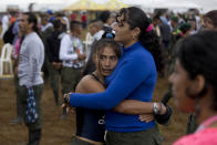 <p>Rebels of the Revolutionary Armed Forces of Colombia, FARC, embrace after the inauguration of its last conference as a rebel army in Yari Plains, Colombia, Sept. 17, 2016. The top FARC leader known by his alias Timochenko said that over the next week commanders will ratify a peace accord reached with the government last month and debate political strategy going forward. (Photo: Ricardo Mazalan/AP) </p>