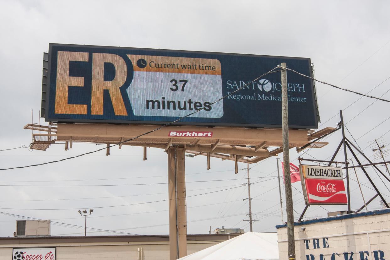 The digital billboard above the Linebacker Lounge announces the SJRMC ER wait time. The owner of the sign, Burkhart Advertising of South Bend, has sold its outdoor advertising business to a firm based in Louisiana.
South Bend Tribune/RYAN KETTERER