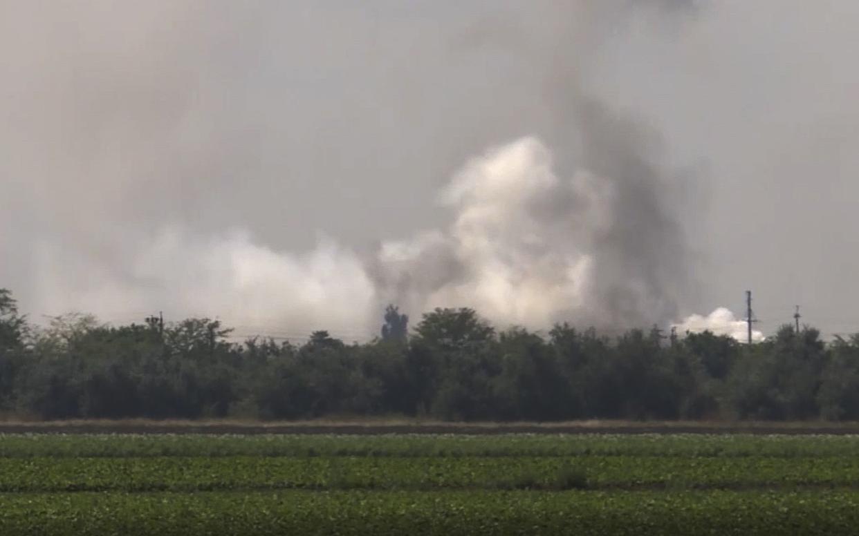 In this image taken from video provided by the RU-RTR Russian television on Tuesday, Aug. 16, 2022, smoke rises over the site of explosion at an ammunition storage of Russian army near the village of Mayskoye, Crimea.