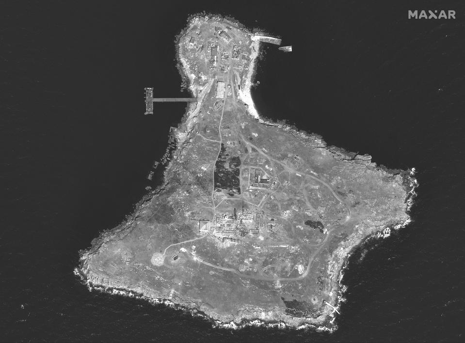 This WorldView-1 satellite black and white image from Maxar Technologies shows an overview of Snake Island, in the Black Sea, on Tuesday, June 21, 2022. There is damage to the tower on the southern end of the island and burned vegetation in several locations. (Satellite image ©2022 Maxar Technologies via AP)