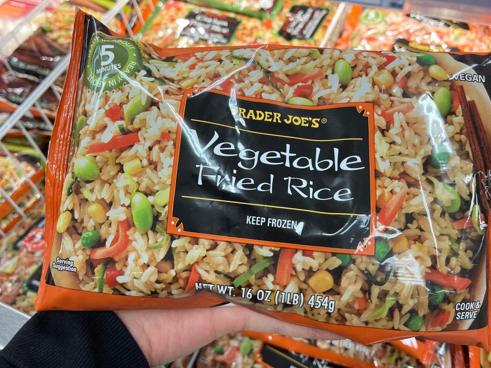 hand holding up a bag of vegetable fried rice at trader joes