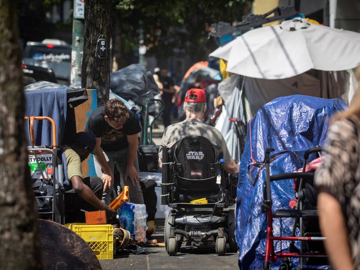 Tents are pictured along the sidewalk on East Hastings near Main Street in the Vancouver's Downtown Eastside. (Ben Nelms/CBC - image credit)