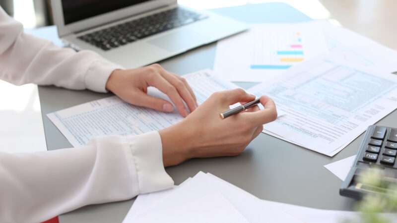 An accountant is seen preparing tax forms