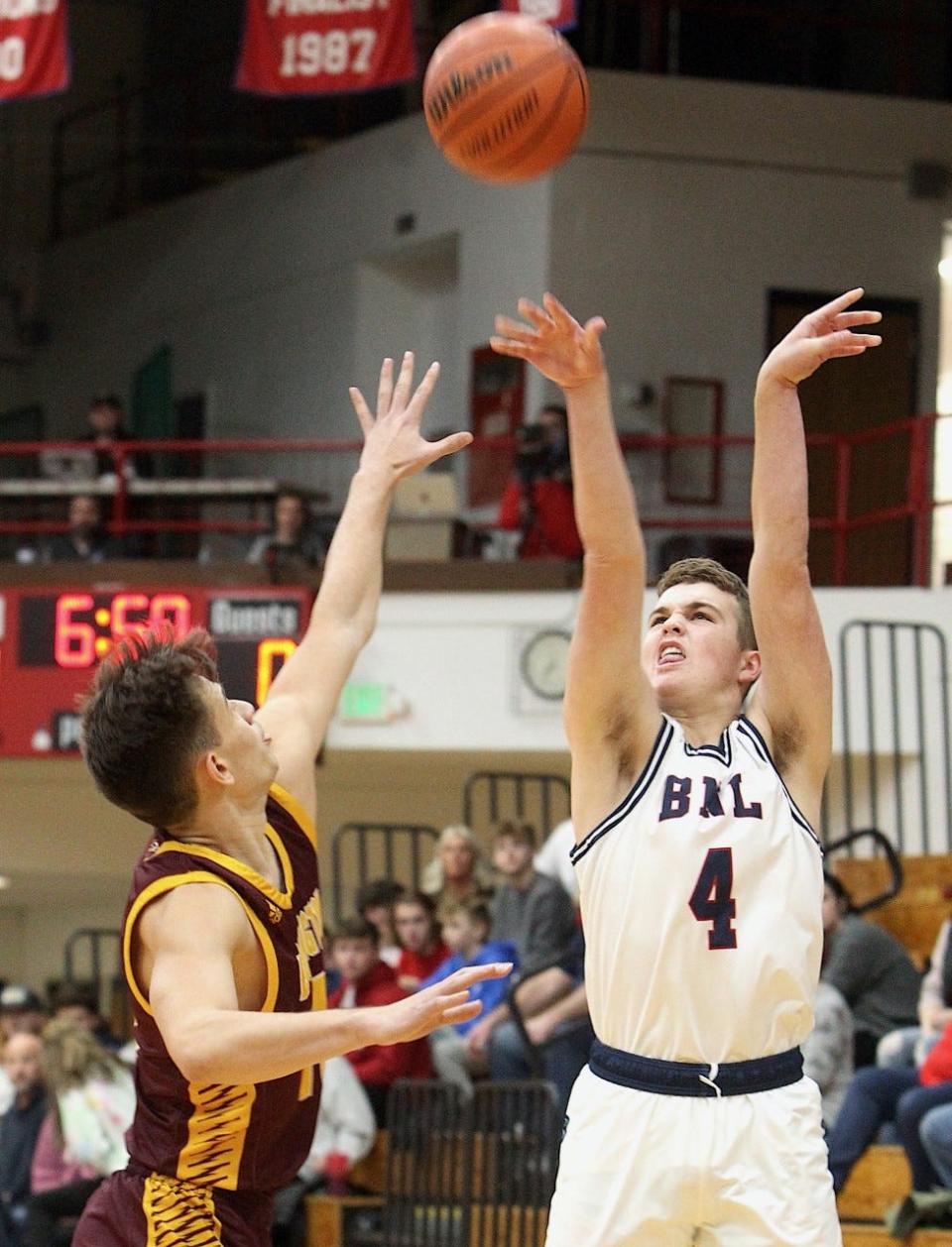 BNL's Kaedyn Bennett fires a trifecta over Bloomington North's Marco Fitch during the Stars' victory Tuesday night at BNL Fieldhouse.