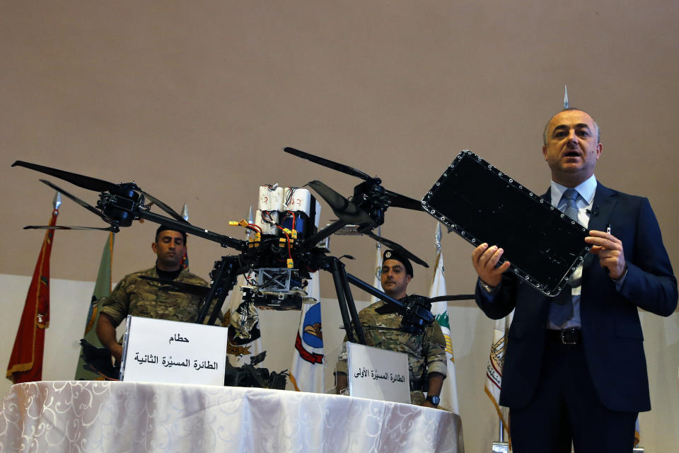 Lebanese Defense Minister Elias Bou Saab holds part of an Israeli drone that crashed in southern Beirut last month during a press conference to announce the results of an investigation into the incident, at the Lebanese Defense Ministry, in Yarzeh near Beirut, Lebanon, Thursday, Sept. 19, 2019. The investigation has concluded that two Israeli drones that crashed in the Lebanese capital last month were on an attack mission, one of them armed with 4.5 kilograms of explosives. (AP Photo/Bilal Hussein)