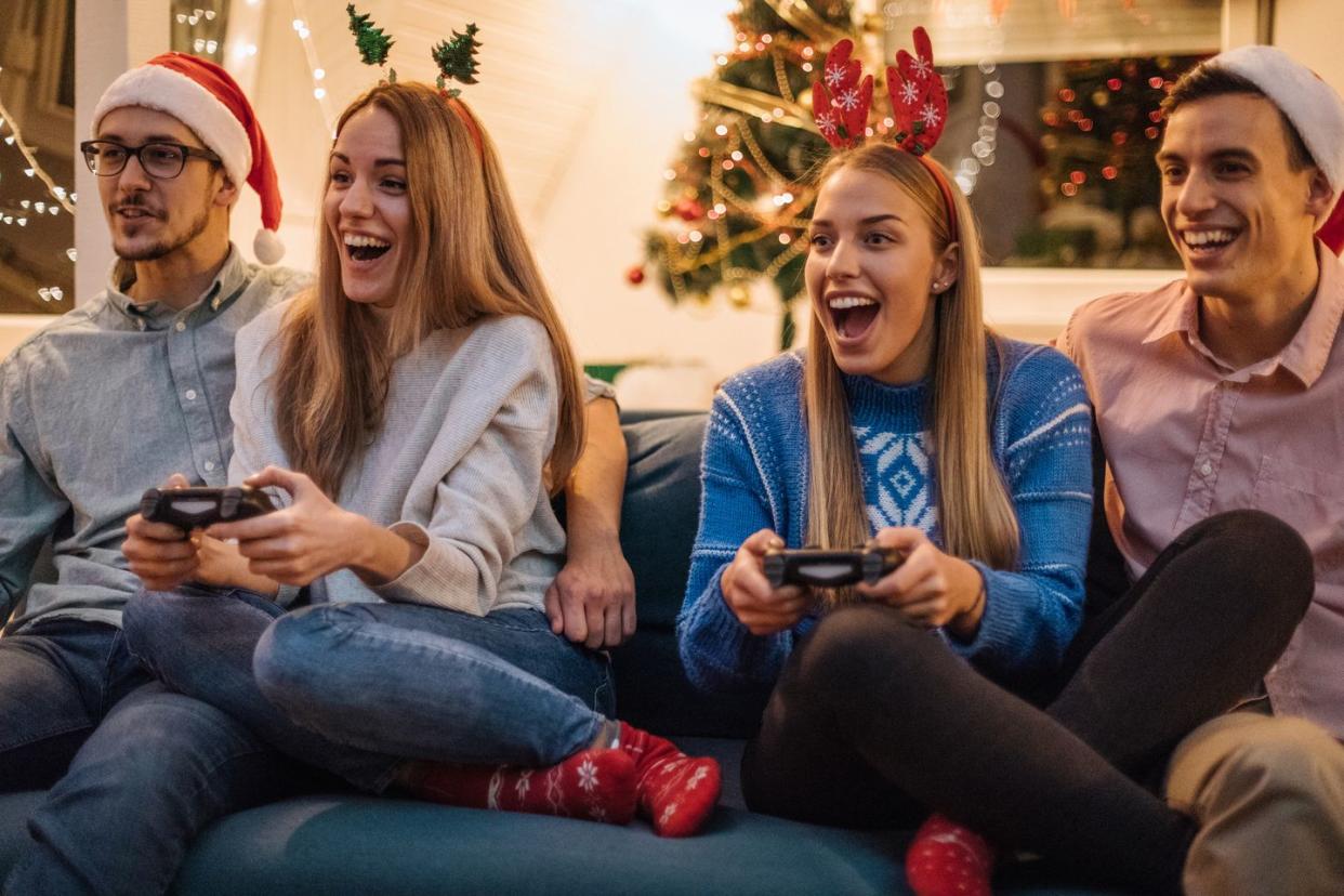 group of generation z friends playing video game