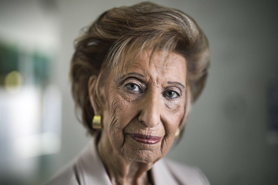 Holocaust survivor Lore Mayerfeld poses at the preview of an exhibition with items from Israel's Yad Vashem Holocaust memorial in the German parliament Bundestag in Berlin, Germany, Monday, Jan. 23, 2023. An exhibition marking the 70th anniversary of Israel's Yad Vashem Holocaust memorial brings back to Germany a diverse set of everyday objects that Jews took with them when they fled the Nazis. (AP Photo/Markus Schreiber)