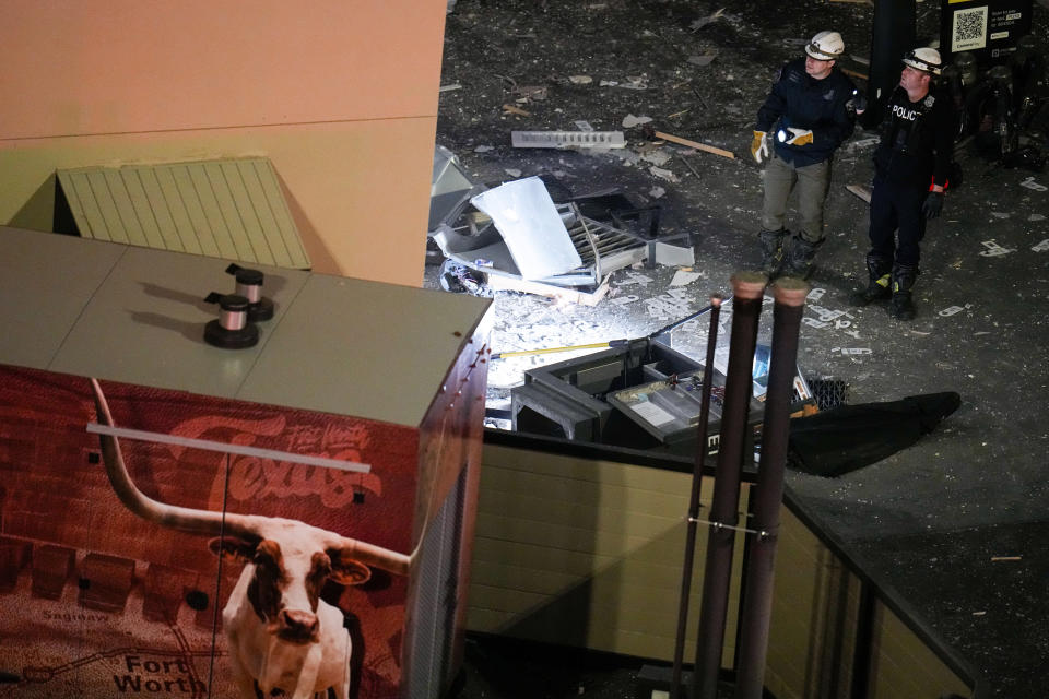 Investigators survey an area near the Sandman Signature hotel following an explosion, Monday, Jan. 8, 2024, in Fort Worth, Texas. (AP Photo/Julio Cortez)