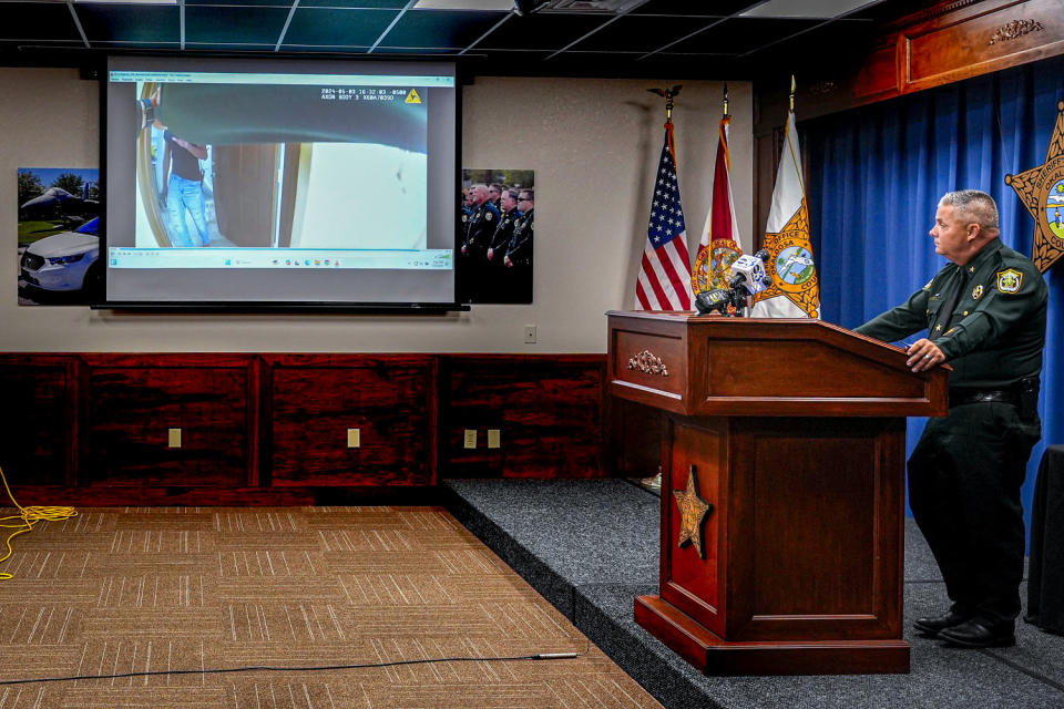 Footage of the shooting of Roger Fortson, displayed on screen at center. (Gerald Herbert / AP)
