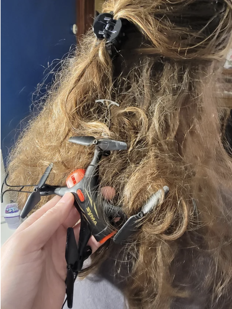 A small drone stuck in someone's hair