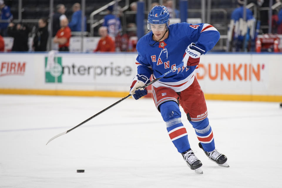 New York Rangers defenseman Braden Schneider warms up before an NHL hockey game against the Calgary Flames, Monday, Feb. 12, 2024, in New York. (AP Photo/Bryan Woolston)