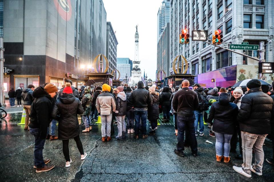 A crowd waits for admission to the College Football Playoff National Championship concerts after a bomb threat delayed the start of Saturday's Doja Cat show at Monument Circle in Indianapolis.