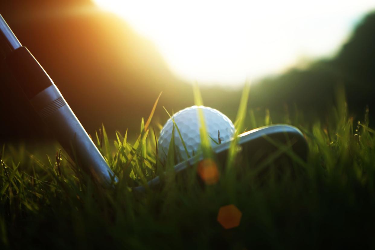 Golf club and golf ball close up.