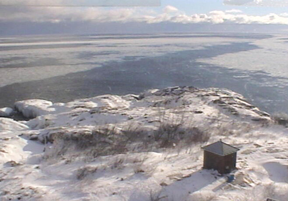 In this image from video provided by the Granite Island Light Station LLC, ice covers the water surrounding Granite Island in Lake Superior Wednesday, Jan 8, 2014 near Marquette, Mich. It may be hard to think of this week's deep freeze as anything but miserable. But in the realm of nature, there are silver linings: Heavy ice cover may help raise low water in the Great Lakes and protect shorelines and wetlands from erosion. (AP Photo/Granite Island Light Station LLC)
