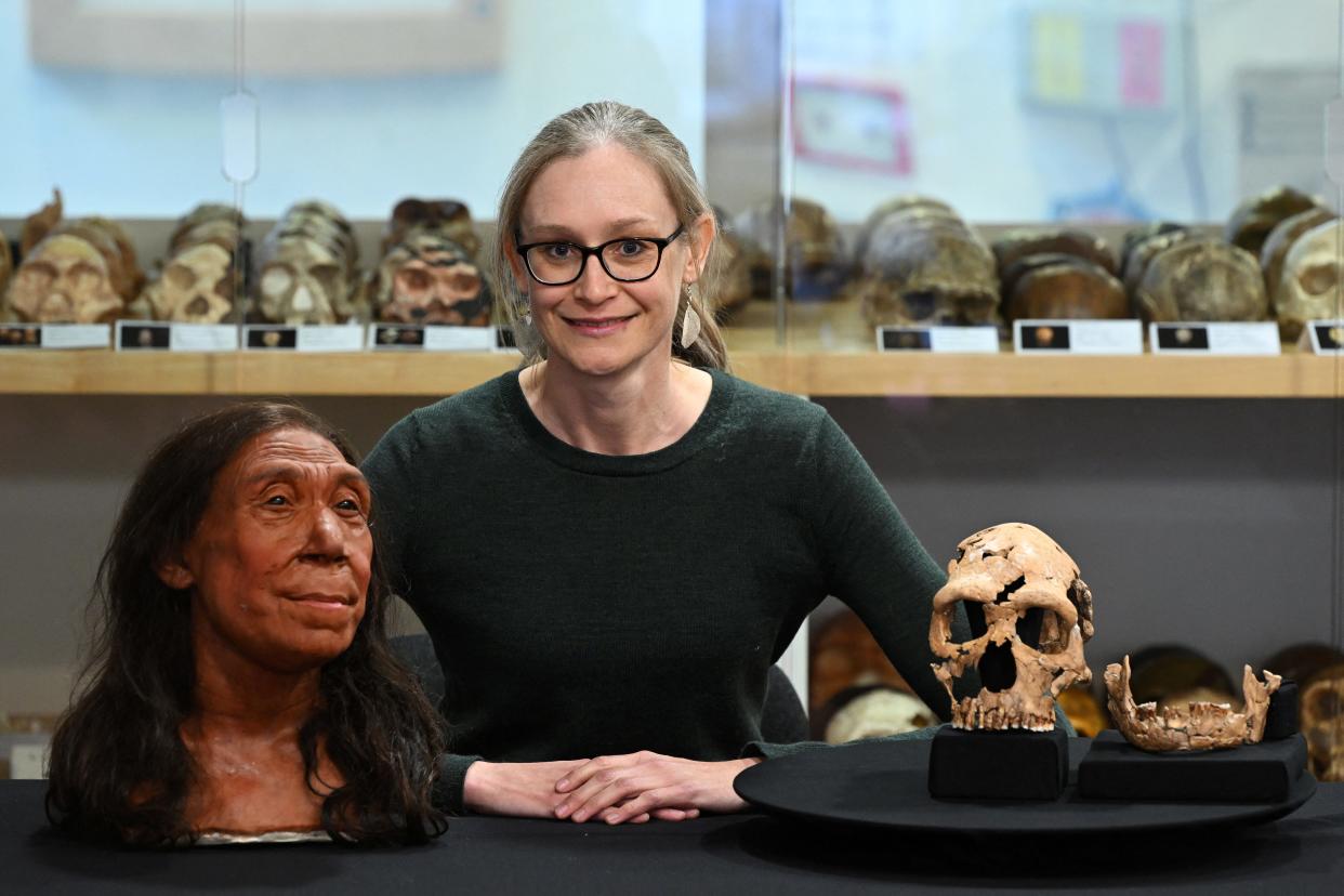 Associate Professor in the Evolution of Health, Diet and Disease, Emma Pomeroy, poses for a photograph with the rebuilt skull and physical reconstruction of the face and head of a 75,000-year-old Neanderthal woman named Shanidar Z at the University of Cambridge on April 25, 2024.