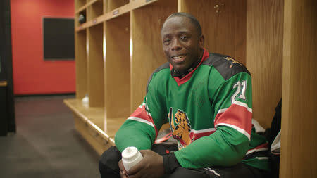 Kenya Ice Lions team captain Benard Azegere poses for a photograph in the locker room following his squad's first game in Toronto, Ontario, Canada, in this still image handout photo taken from video August 14, 2018 and provided October 16, 2018. Tim Horton's/Handout via REUTERS