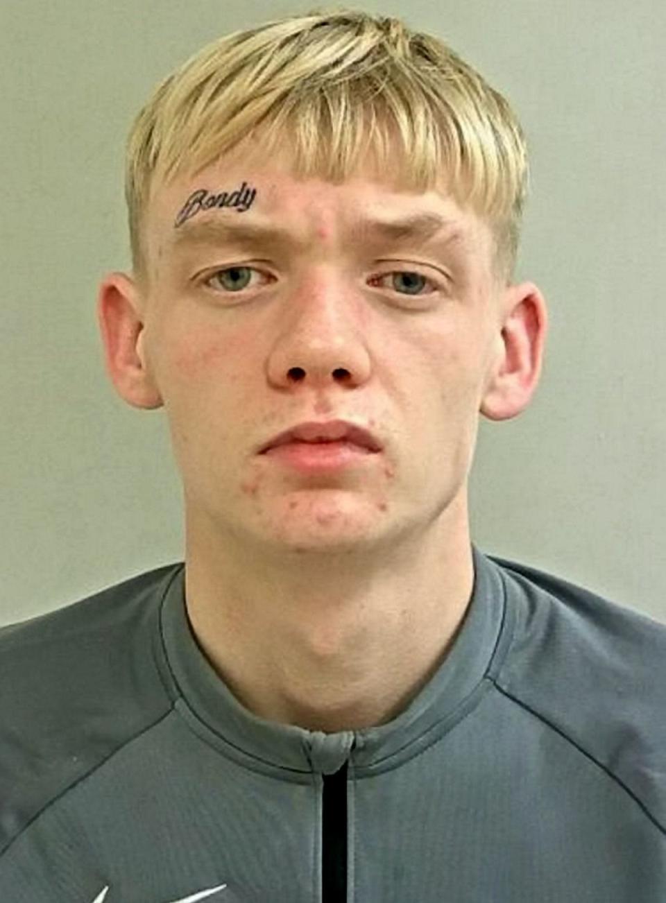 Prison bosses have launched an investigation after a teenager was apparently able to post photos of himself on Facebook from his remand cell.

Kieran Bond - who has 'Bondy' tattooed on his forehead - had been on the run for three months after failing to turn up at court to face charges of making threats with an offensive weapon.

A nationwide manhunt was launched by British Transport Police for the 19-year-old fugitive over allegations that he made threats while wielding a machete on a train on March 29 last year.

Bond, of Lichfield Road, Stafford, was finally arrested on Christmas Eve after failing to appear at Cannock Magistrates' Court on October 26. However, after being detained Bond appeared to take to Facebook to share pictures from his remand cell in Greater Manchester.

One of the pictures is tagged with the location of HMP Forest Bank in Salford and was posted at 8.54am yesterday. A second picture - which now appears to have been deleted - appeared to show him posing with fellow inmates while giving a one-fingered salute to the camera.