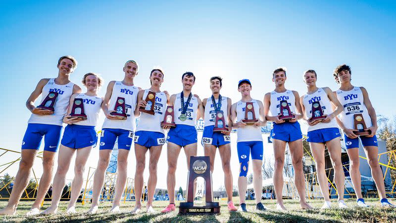 Members of the BYU men’s cross-country team pose with their hardware after finishing third at the NCAA cross-country championships Saturday, Nov. 18, 2023.