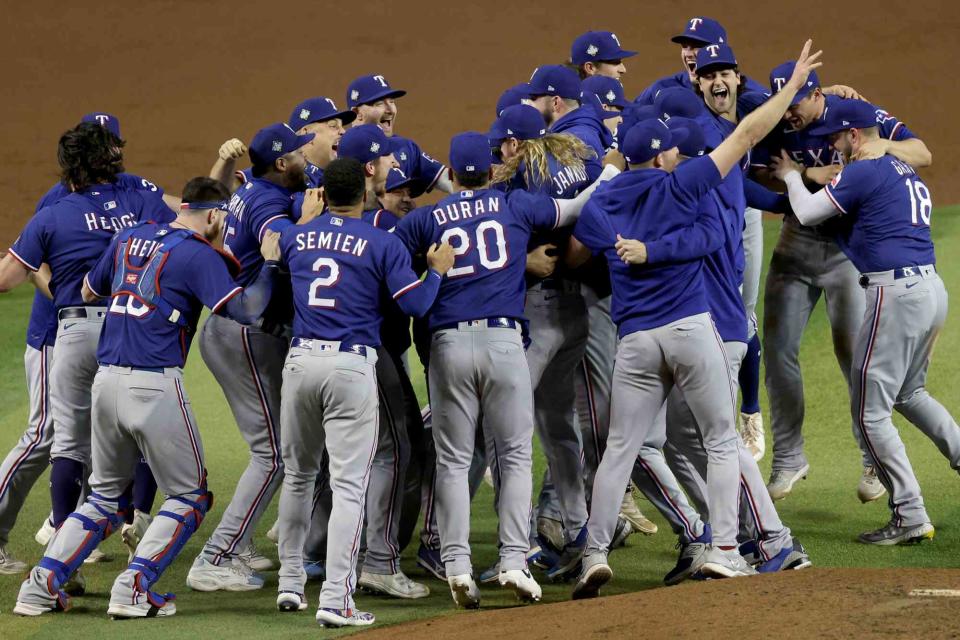 <p>Jamie Squire/Getty</p> Texas Rangers celebrate their first-ever World Series victory