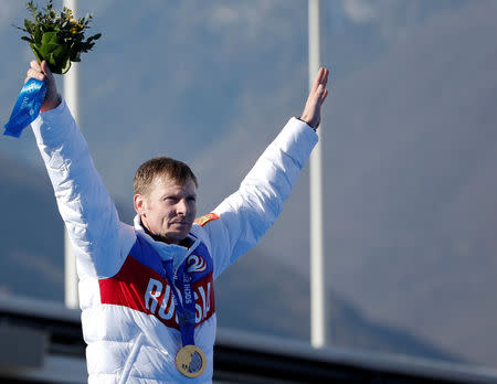 FILE PHOTO: Russia's pilot Alexander Zubkov poses with a gold medal during a ceremony for the four-man bobsleigh event at the Sochi 2014 Winter Olympics, at the Sanki Sliding Center in Rosa Khutor Alpine Ski Resort near Sochi, Russia, February 23, 2014. REUTERS/Murad Sezer