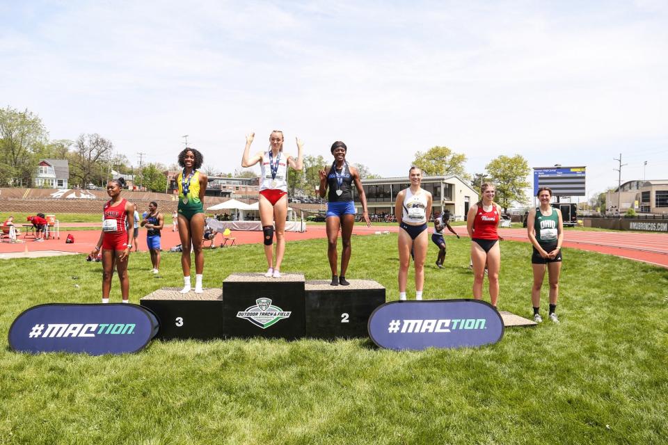 Ball State's Charity Griffith stands on the podium at the Mid-American Conference championships after her first-place finish in the high jump.