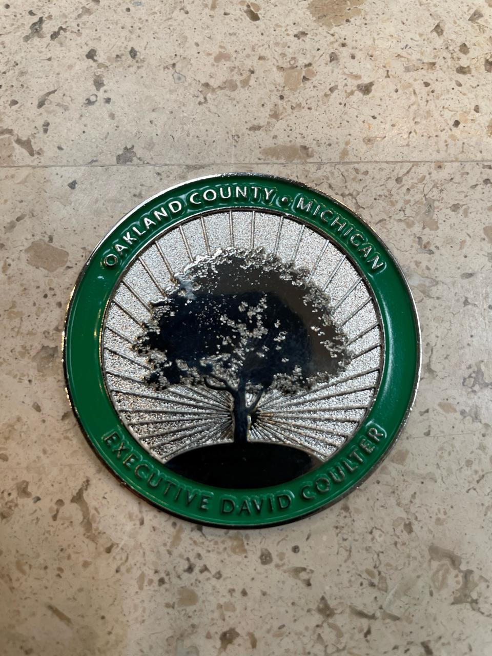 Obverse of the new Challenge Coin minted by Oakland County displays the oak tree logo and the name of Oakland County Executive David Coulter. He handed out hundreds of the keepsakes Tuesday night at a speech.