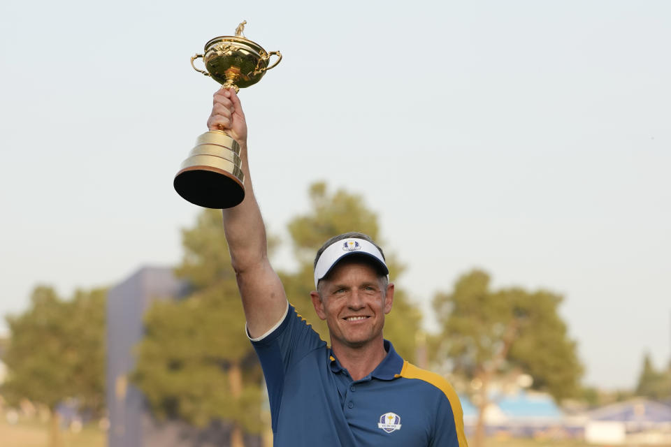 Europe's Team Captain Luke Donald holds the Ryder Cup aloft after Europe won the trophy at the Marco Simone Golf Club in Guidonia Montecelio, Italy, Sunday, Oct. 1, 2023. (AP Photo/Alessandra Tarantino)