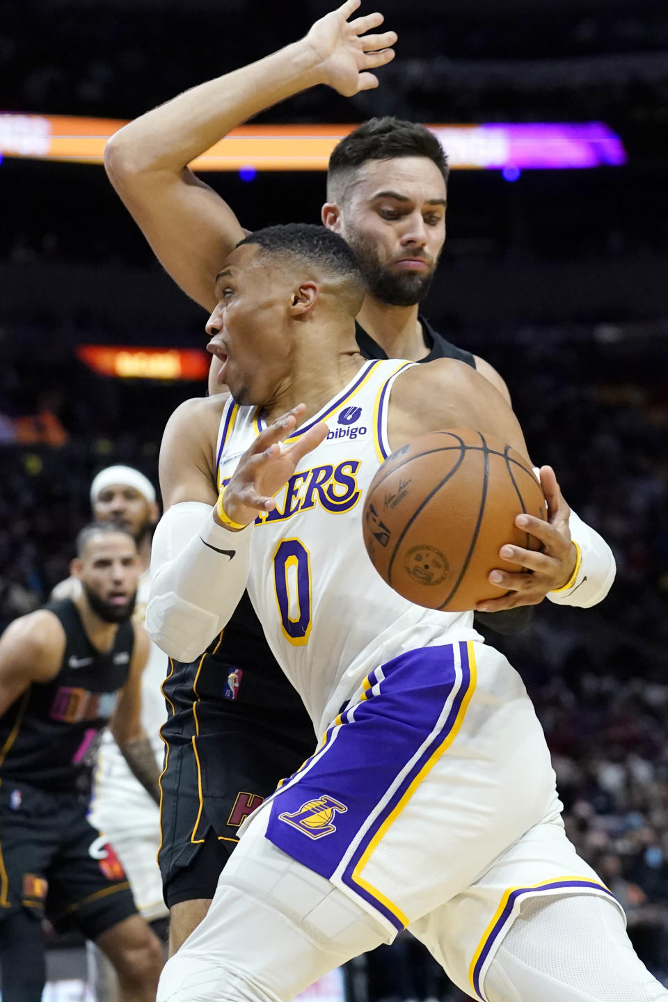 Los Angeles Lakers guard Russell Westbrook (0) drives to the basket as Miami Heat guard Max Strus defends during the first half of an NBA basketball game, Sunday, Jan. 23, 2022, in Miami. (AP Photo/Lynne Sladky)