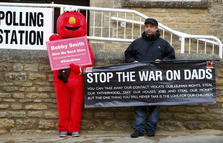 Two activists stand outside the polling station where Britain's Prime Minister David Cameron is due to vote in Spelsbury, central England, Britain, May 7, 2015. REUTERS/Eddie Keogh