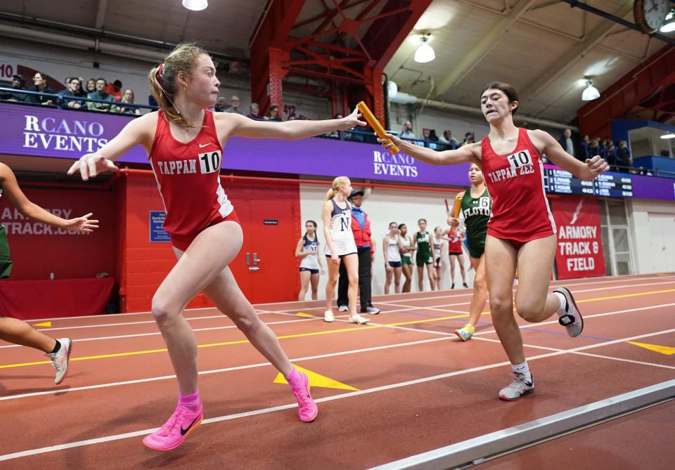 Tappan Zee's Mia Dellolio hands off to Sofia Fenton in the 4x800-meter relay at the Millrose Trials at The Armory in New York on Wednesday, January 11, 2023.