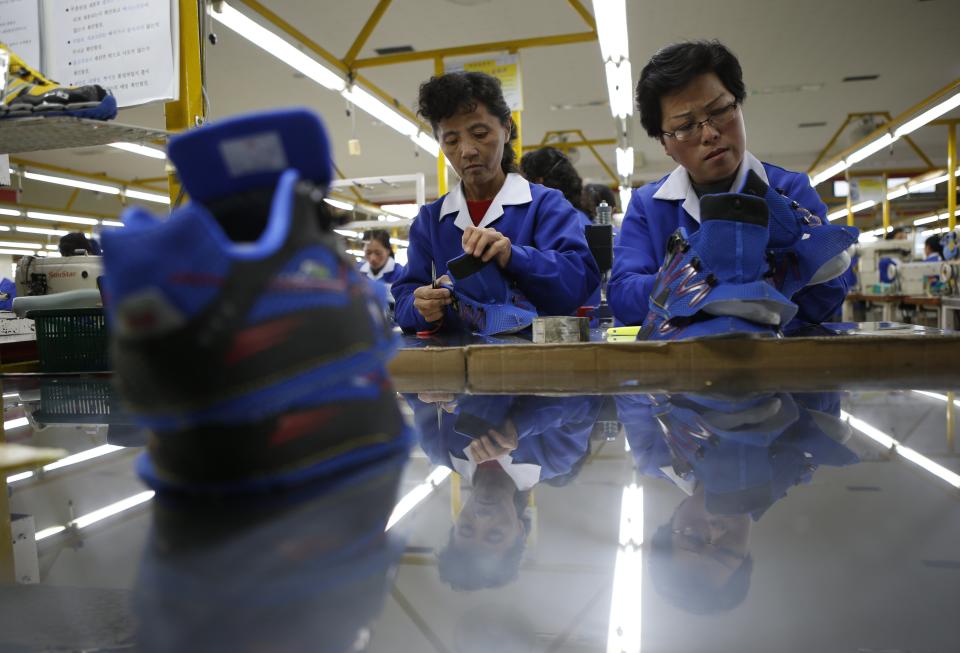 North Korean employees work in a factory of a South Korean company at the Joint Industrial Park in Kaesong industrial zone, a few miles inside North Korea from the heavily fortified border December 19, 2013. Kaesong, with investors from South Korea, was a rare source of hard currency for North Korea. It was established even though North Korea is technically still at war with South Korea, one of the world's richest countries, since the 1950-53 Korean War ended not in a treaty but a truce. Since it opened in 2004, the Kaesong complex has generated about $90 million annually in wages paid directly to the North's state agency that manages the zone. REUTERS/Kim Hong-Ji (NORTH KOREA - Tags: POLITICS BUSINESS EMPLOYMENT)