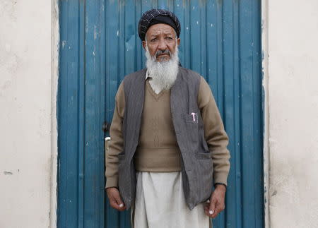 Former Guantanamo Bay detainee Mohammed Zahir poses for a photo outside his work place in Kabul, Afghanistan November 19, 2015. REUTERS/Ismail Azami