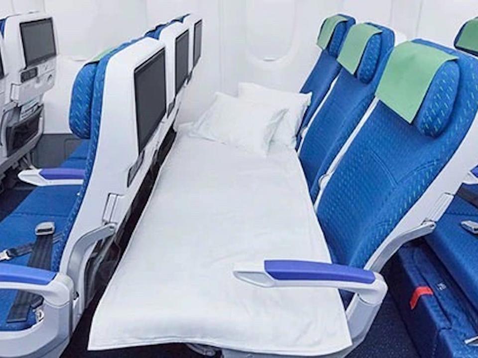 A COUCHii aboard an ANA A380 airline with linens on it.