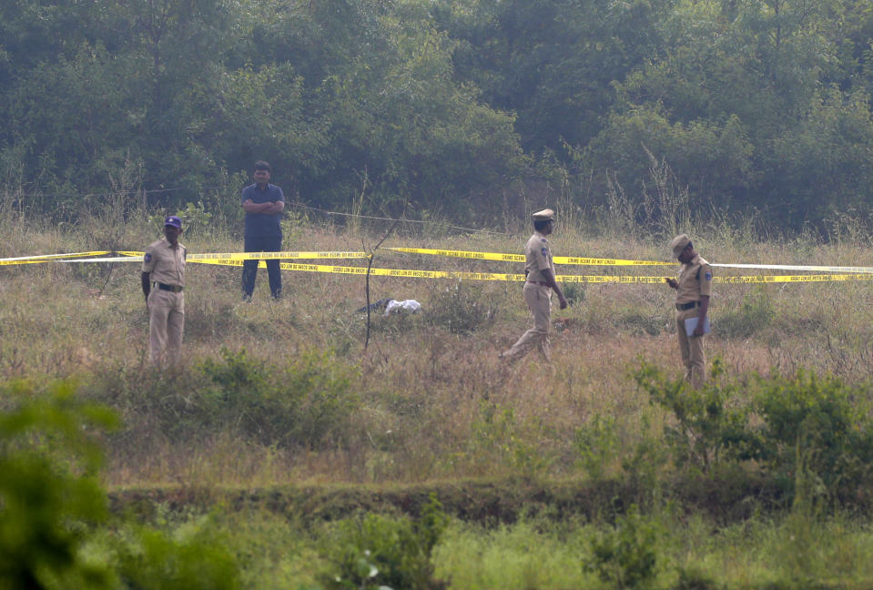 Indian policemen stand guard the area where rape accused were shot on the outskirts of Chattanpally in Shadnagar some 50 kilometers or 31 miles from Hyderabad, India, Friday, Dec. 6, 2019. An Indian police official says four men accused of raping and killing a woman in southern India have been fatally shot by police. (AP Photo/Mahesh Kumar A.)