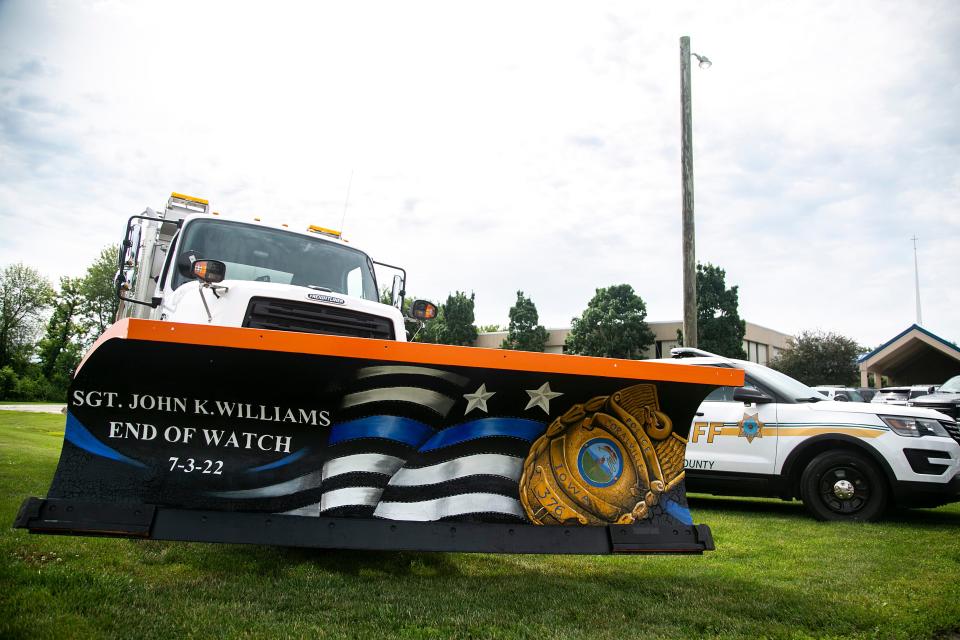 A Coralville snowplow has an "end of watch" memorial painted on it to honor Coralville police Sgt. John Williams on Monday at Grace Community Church in North Liberty.