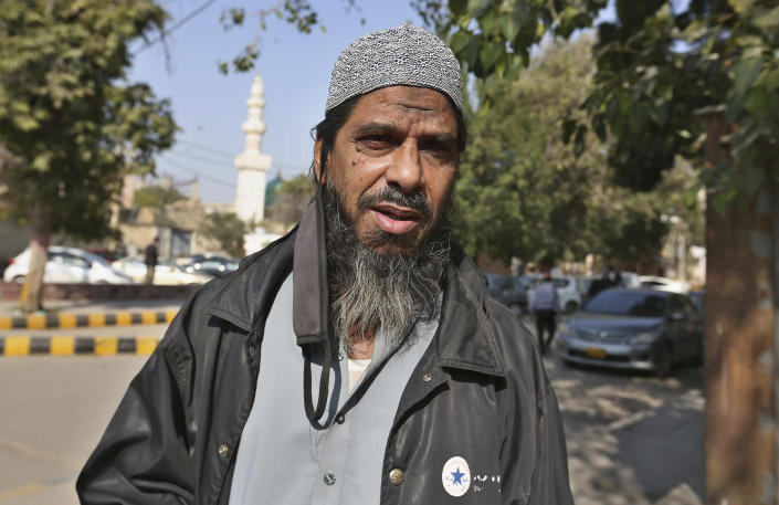 Sheikh Muhammad Aslam, brother of British-born Pakistani Ahmed Omar Saeed Sheikh, who is charged in the 2002 murder of American journalist Daniel Pearl, leaves the Sindh High Court, in Karachi, Pakistan, Thursday, Dec. 24, 2020. The provincial court overturned a Supreme Court Decision that Ahmed Omar Saeed Sheikh should remain in custody during an appeal of his acquittal on charges he murdered Pearl. (AP Photo/Fareed Khan)