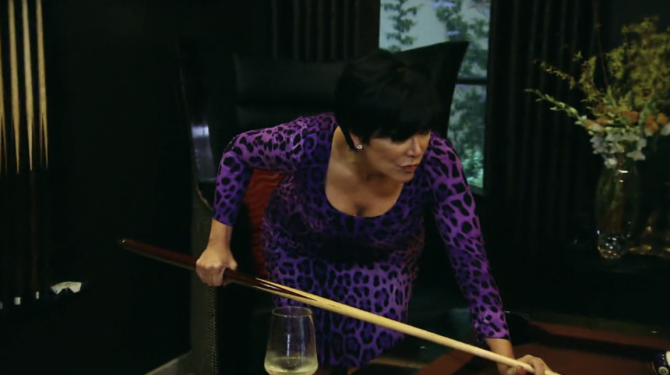<p>Only Kris could wear a purple bodycon leapord print dress to play pool at home. </p>