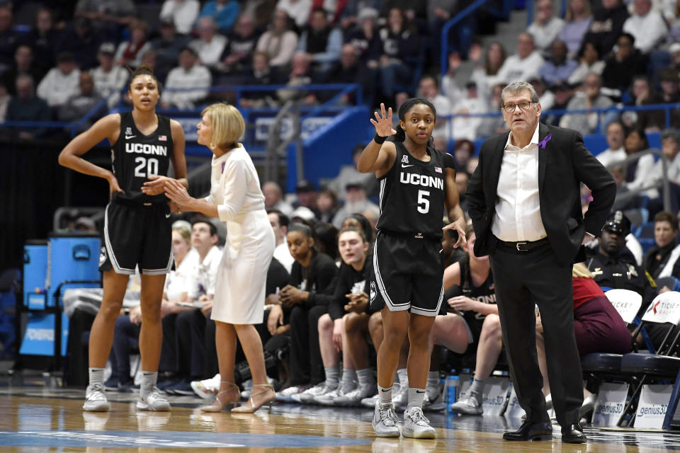 Connecticut head coach Geno Auriemma, right, talks with Connecticut's Crystal Dangerfield (5) as associate head coach Chris Dailey talks with Connecticut's Olivia Nelson-Ododa (20) in the first half of an NCAA college basketball game against Tennessee, Thursday, Jan. 23, 2020, in Hartford, Conn. (AP Photo/Jessica Hill)