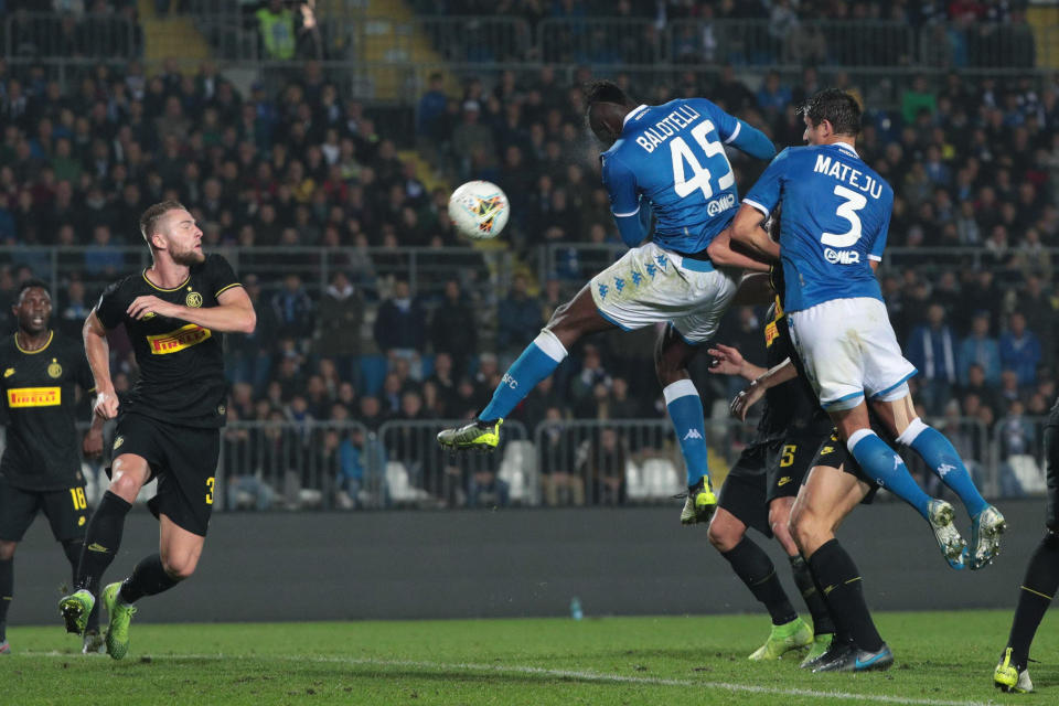 Brescia's Mario Balotelli, centre right, heads the ball, during the Italian Serie A soccer match Brescia and Inter FC, at Rigamonti stadium in Brescia, Italy, Tuesday, Oct. 29, 2019. (Filippo Venezia/ANSA via AP)