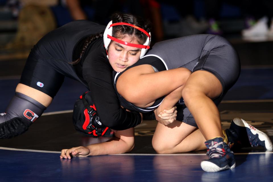 Stefany Morales (shown), a student at International High School and a wrestler on the John F. Kennedy High School Wrestling Team, takes on Katlyn Juarez, of Passaic County Technical Institute, in Wayne.  Wednesday, January 19, 2022