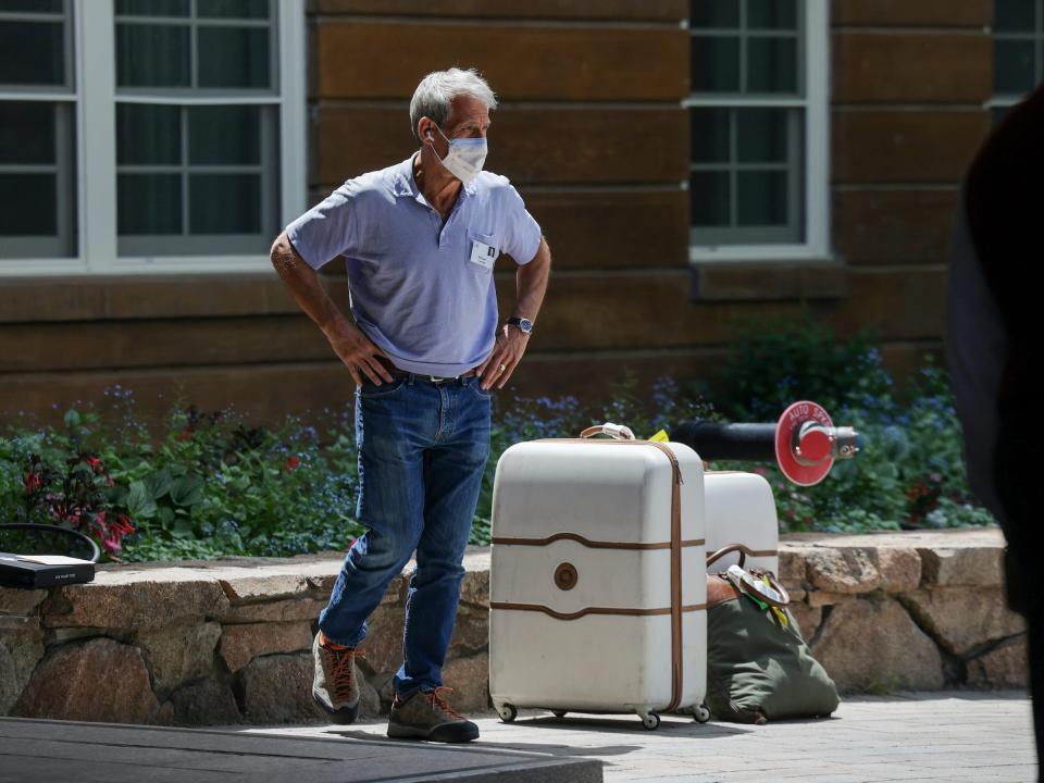 Michael Lynton, Snap chairman, stands next to suitcases at Sun Valley conference