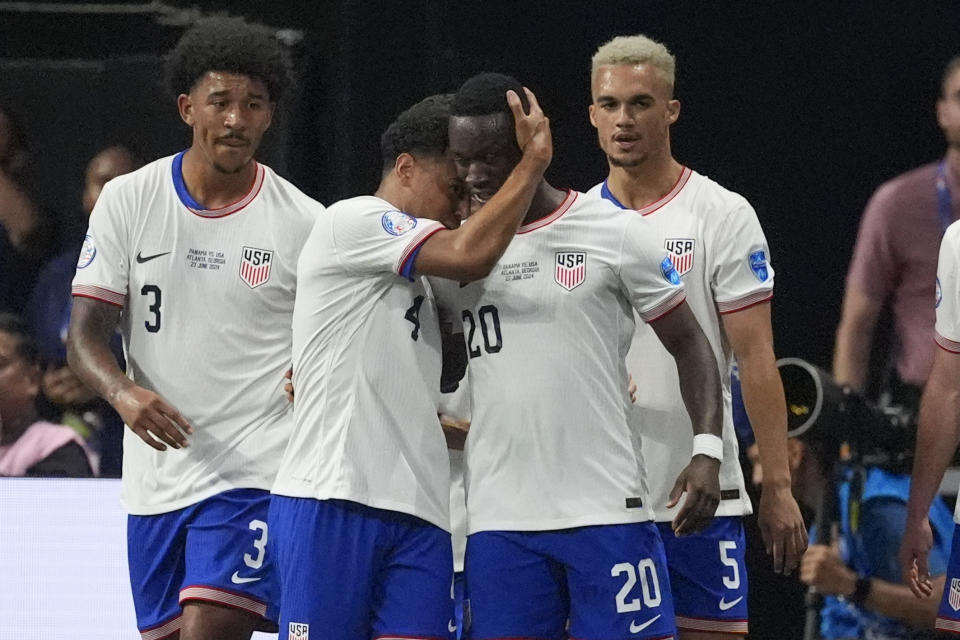 Folarin Balogun of the United States (20), celebrates with teammates after scoring his side's opening goal against Panama during a Copa America Group C soccer match in Atlanta, Thursday, June 27, 2024. (AP Photo/Mike Stewart)