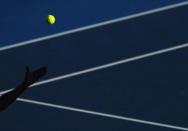 Matthew Ebden of Australia serves to Kei Nishikori of Japan during their men's singles match at the Australian Open tennis tournament in Melbourne January 19, 2012. REUTERS/Mark Blinch/Files