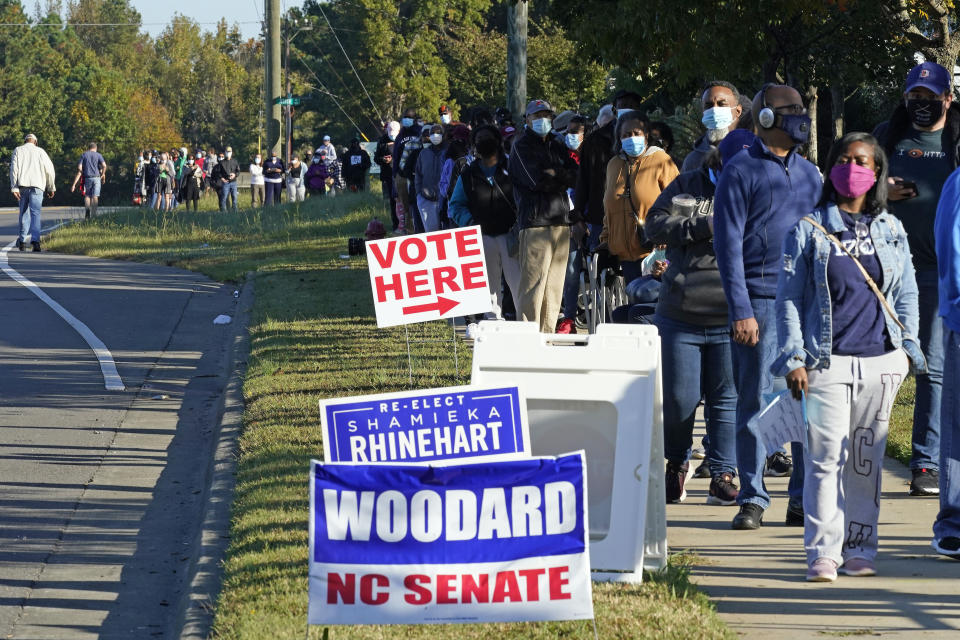 Early voters form a long line while waiting to cast their ballots at the South Regional Library polling location in Durham, North Carolina, on Oct. 15, 2020. Some waited almost three hours to vote.  (Photo: AP Photo/Gerry Broome)