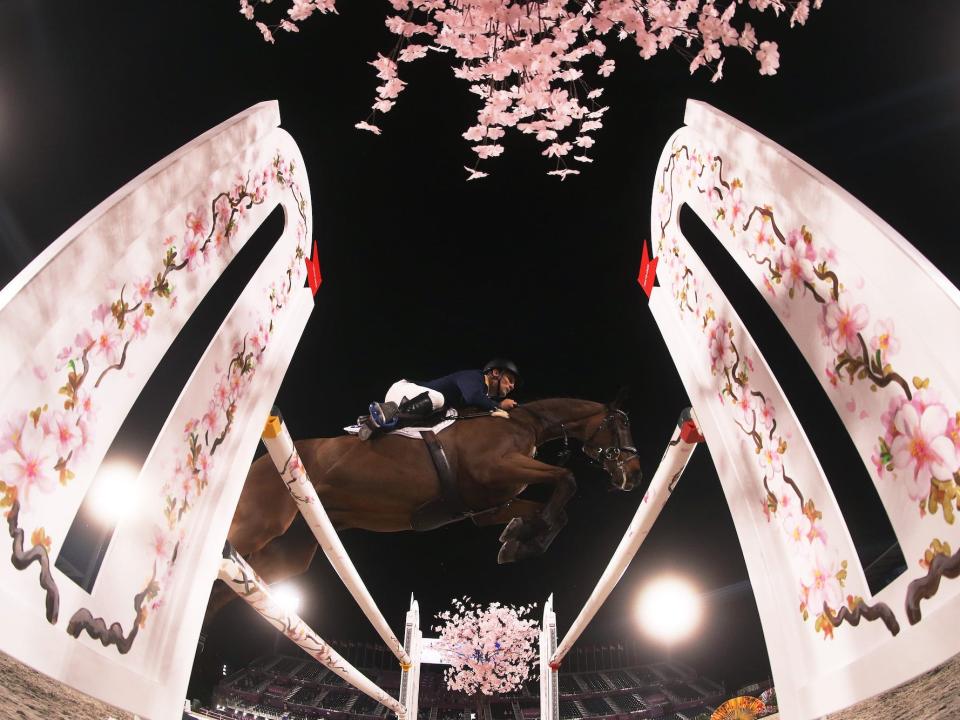 A horse jumps over bars at the Tokyo Olympics