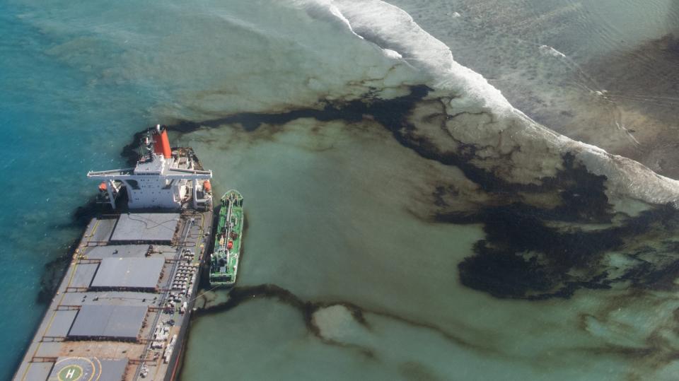 This photo provided by the French Army shows oil leaking from the MV Wakashio, a bulk carrier ship that ran aground off the southeast coast of Mauritius, Tuesday Aug.11, 2020. Thousands of students, environmental activists and residents of Mauritius were working around the clock trying to reduce the damage to the Indian Ocean island from an oil spill after a tanker ran aground on a coral reef. An estimated 1 ton of oil from the Japanese ship's cargo of 4 tons has already escaped into the sea, officials said. (Gwendoline Defente, EMAE via AP)