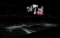 A video tribute is played overhead scoreboard to former Colorado Avalanche general manager and president Pierre Lacroix, before the Avalanche's NHL hockey game against the St. Louis Blues on Wednesday, Jan. 13, 2021, in Denver. Lacroix died last month from complications of COVID-19. (AP Photo/David Zalubowski)